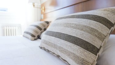 two pillow rests on a hotel bed.